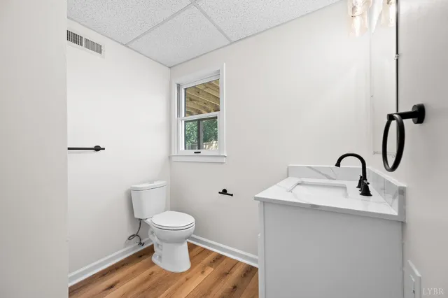 a bathroom with a sink toilet and a mirror