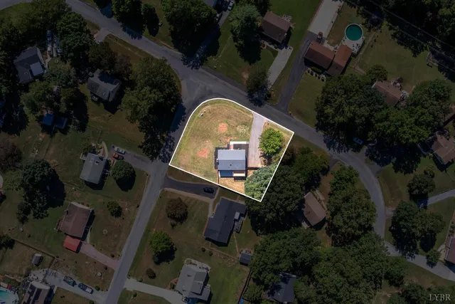 an aerial view of a house with garden space and street view