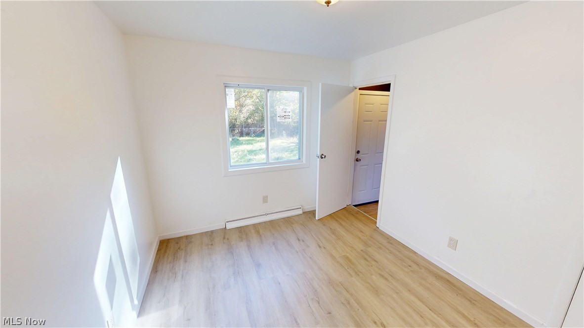 693 Liberty Road Youngstown, OH 44505 - Photo 9 of 14 Light wood-finish flooring, white walls, and a visible window
