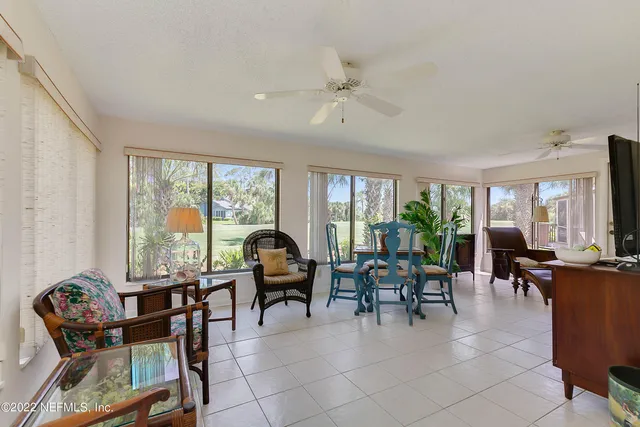 a living room with furniture and large windows