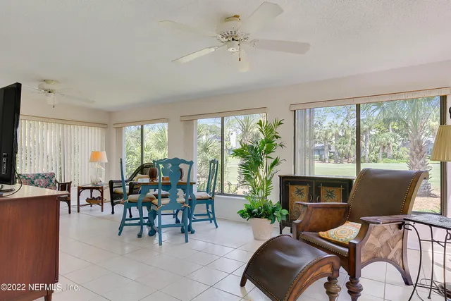 a living room with furniture a fireplace and a large window