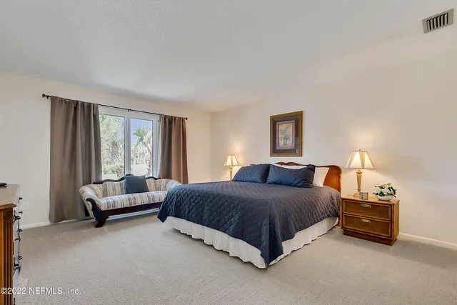 a living room with a bed furniture and a large window