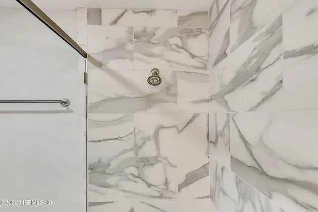 a bedroom with furniture and a large window