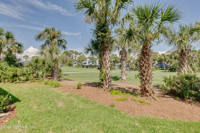 a view of a house with a yard and sitting area