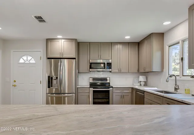 a kitchen with a refrigerator and a sink