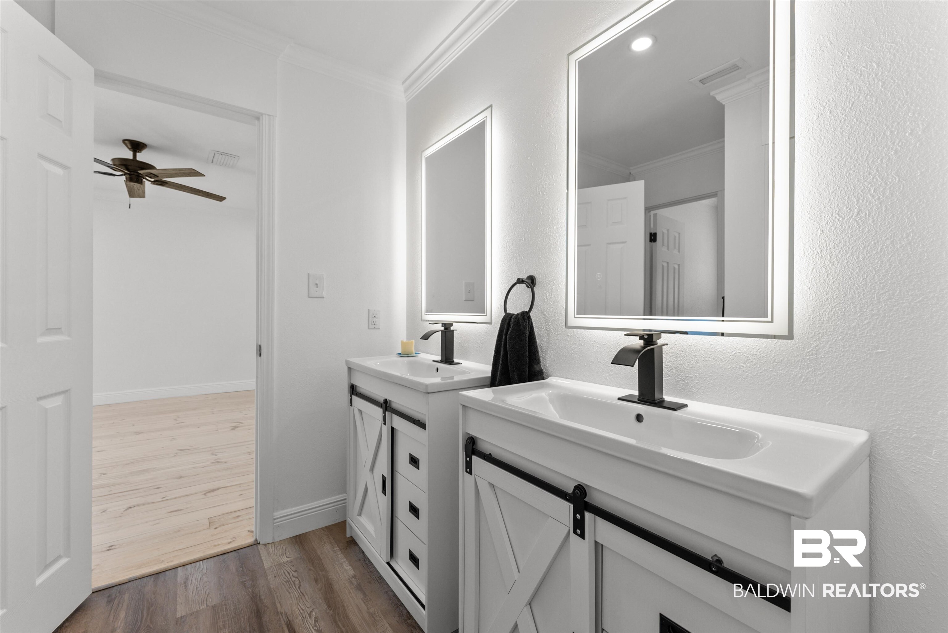 6447 Bemis Lane Bon Secour, AL 36511 - Photo 51 of 62 Dual vanity featuring white barn-door style cabinetry, integrated sinks, and matte black waterfall faucets