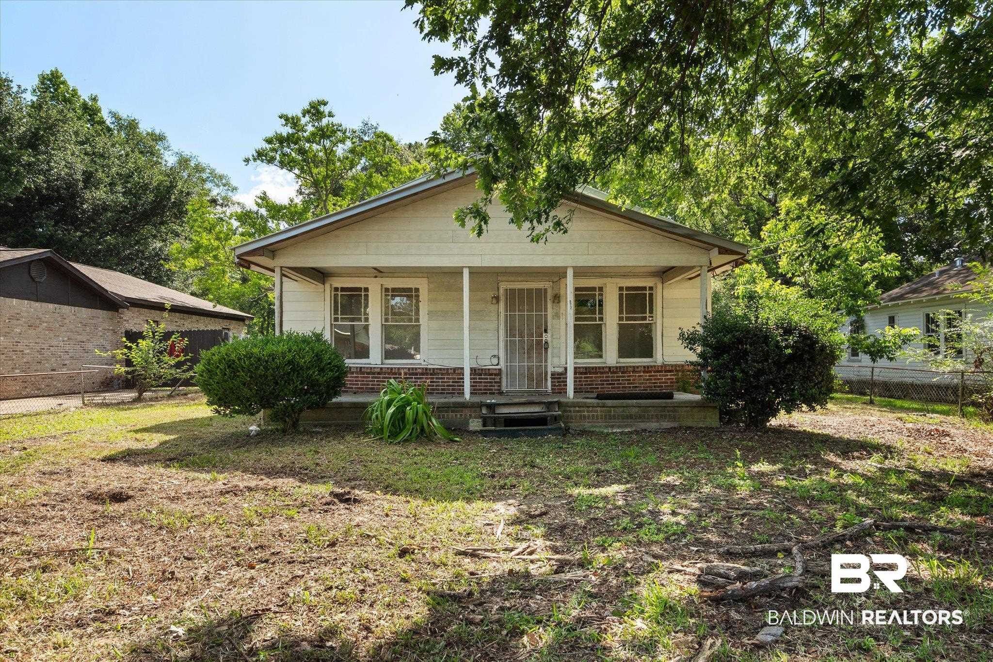 672 Burden Street Mobile, AL 36607 - Photo 1 of 20 Bungalow-style home featuring covered porch, fence, and brick siding