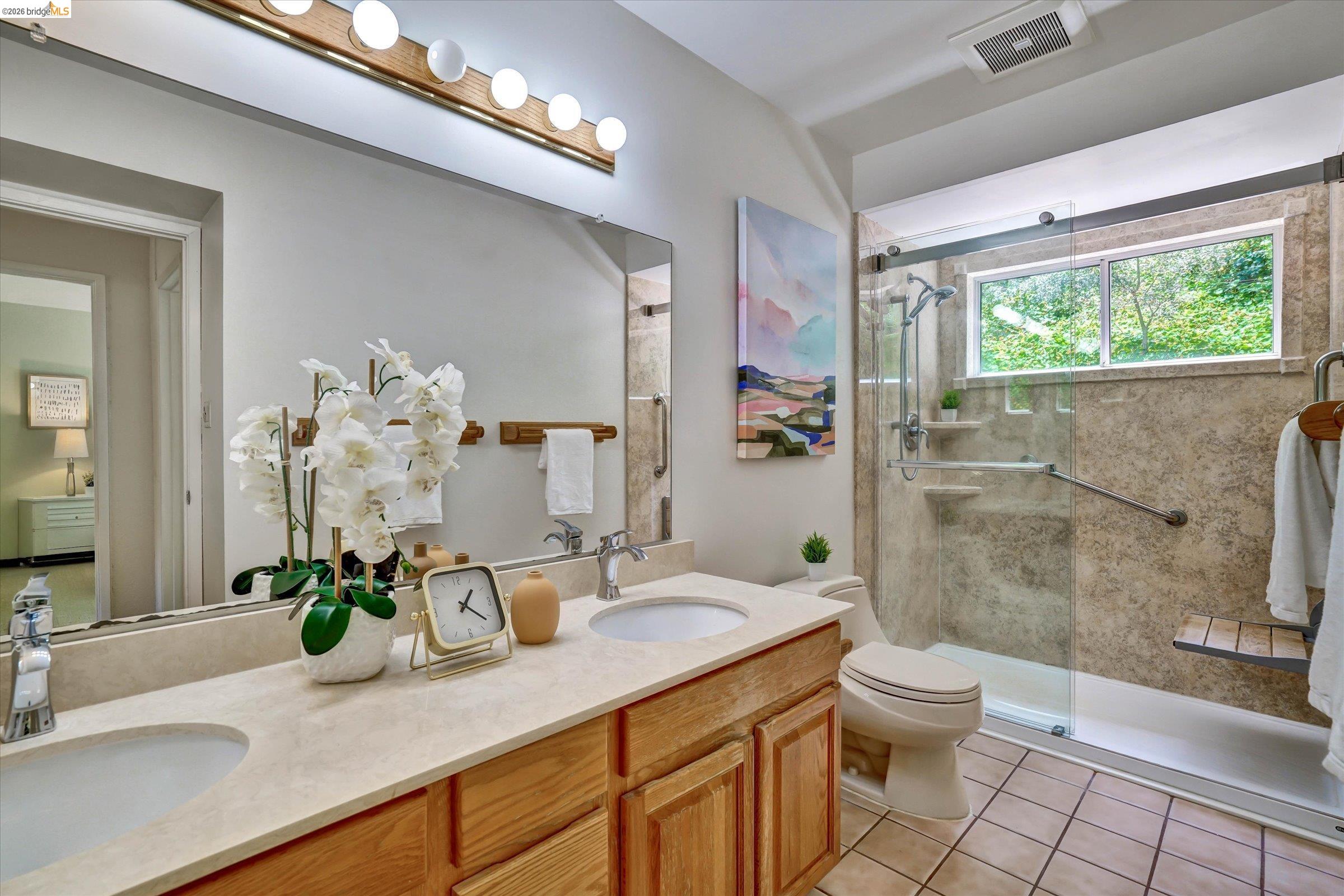 2826 Wright Avenue Pinole, CA 94564 - Photo 31 of 70 Bathroom with a dual-sink vanity featuring a light-toned countertop and wood cabinetry