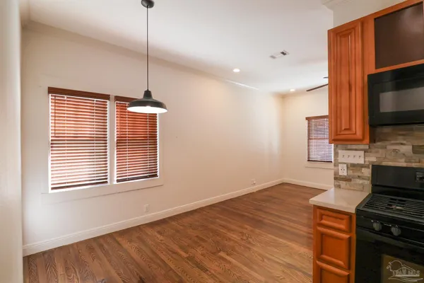a kitchen with wooden floors and a stove