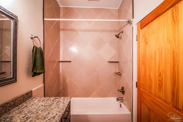 a bathroom with a bathtub and shower