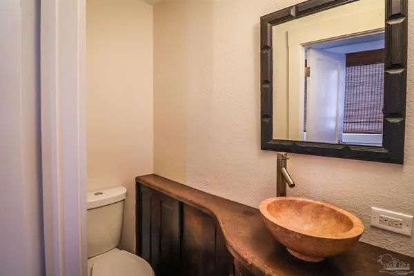 a bathroom with a toilet a sink and mirror