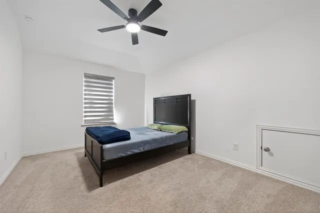 a bedroom with bed and window