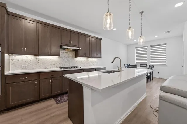 a kitchen with a sink cabinets and window
