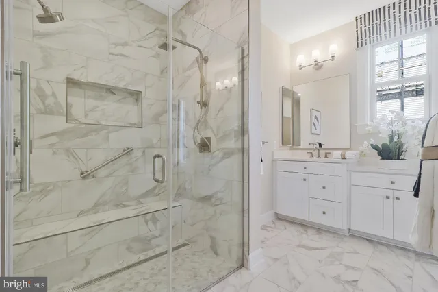 a spacious bathroom with double sink and shower