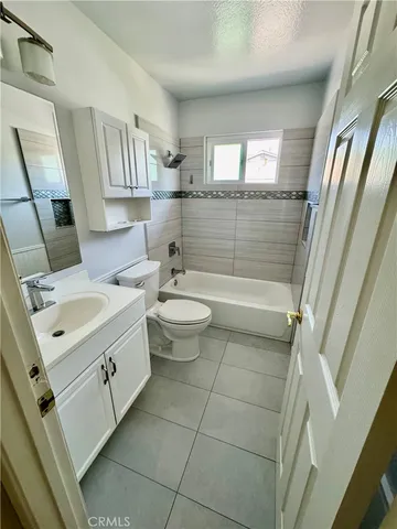 a bathroom with a double vanity sink toilet and shower