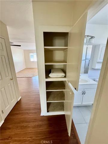 a view of walk in closet with empty racks
