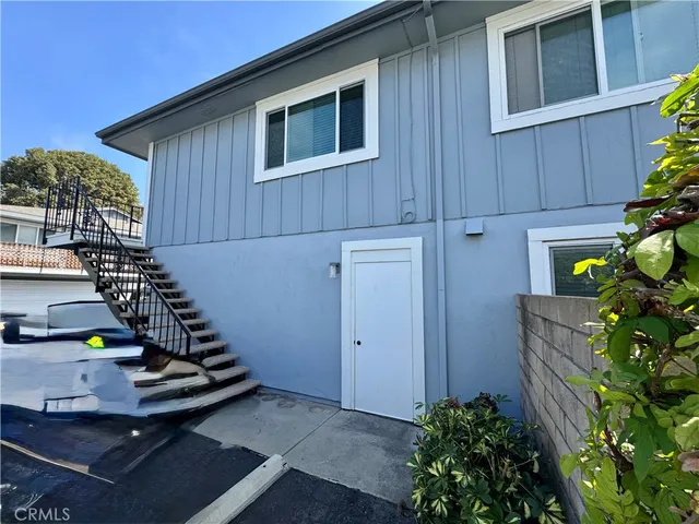 a house with potted plants in front of door