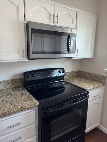 a stove top oven sitting inside of a kitchen