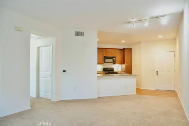 a view of a kitchen with a sink and a refrigerator