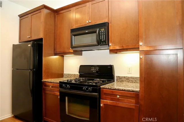 a kitchen with a refrigerator stove and microwave