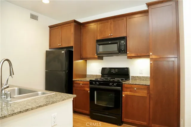 a kitchen with a refrigerator stove and microwave