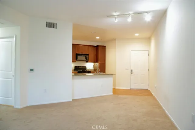 a view of a kitchen with electric appliances