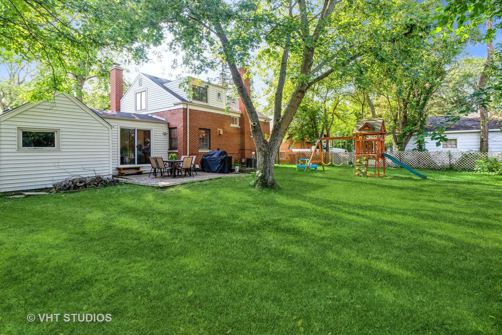 932 Echo Lane Glenview, IL 60025 - Photo 15 of 18 a backyard of a house with table and chairs