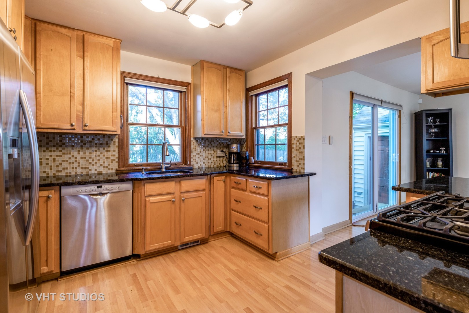 932 Echo Lane Glenview, IL 60025 - Photo 7 of 18 a kitchen with stainless steel appliances granite countertop a stove a sink and a refrigerator