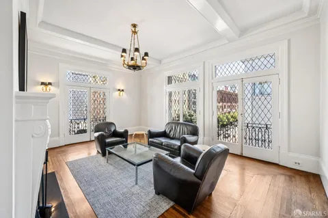 a view of a room that has a window and chairs