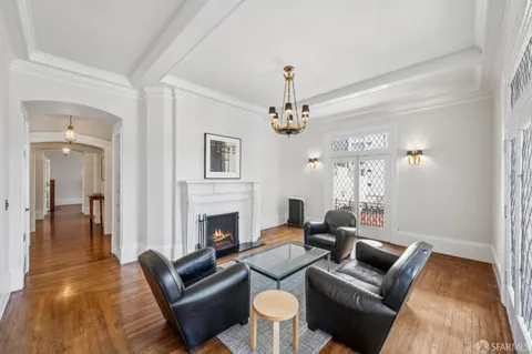 wooden floor with chandelier and glass door