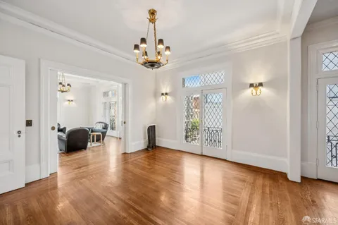 a view of a hallway with wooden floor and staircase