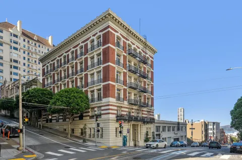 a living room with furniture chandelier and a window