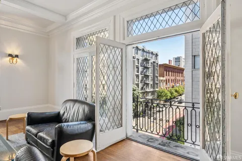 a view of an chairs and table in a room