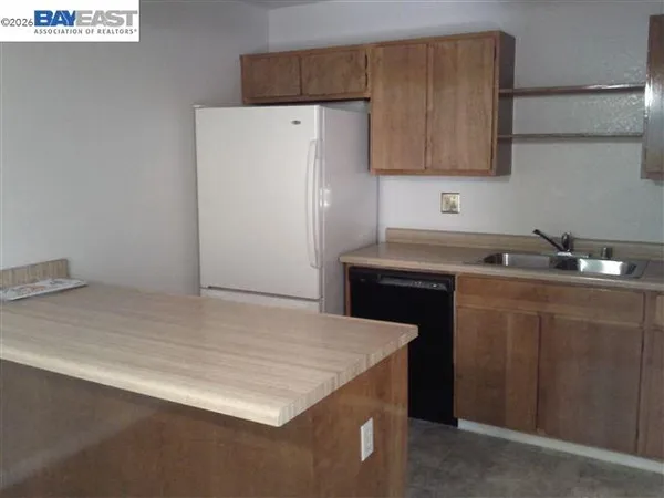 a kitchen with a sink and a refrigerator