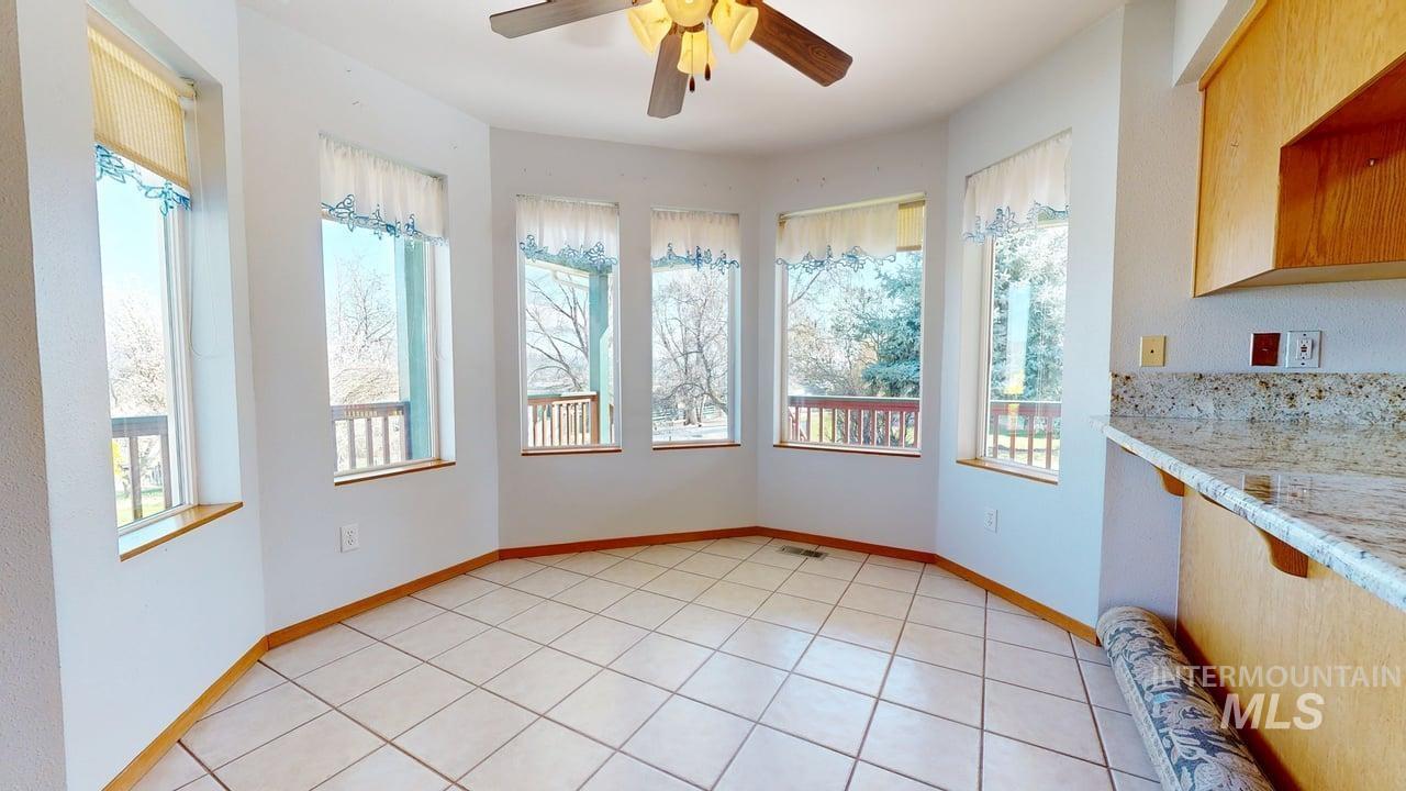 2794 9th Avenue Clarkston, WA 99403 - Photo 10 of 34 Unfurnished dining area featuring a ceiling fan and light tile patterned flooring
