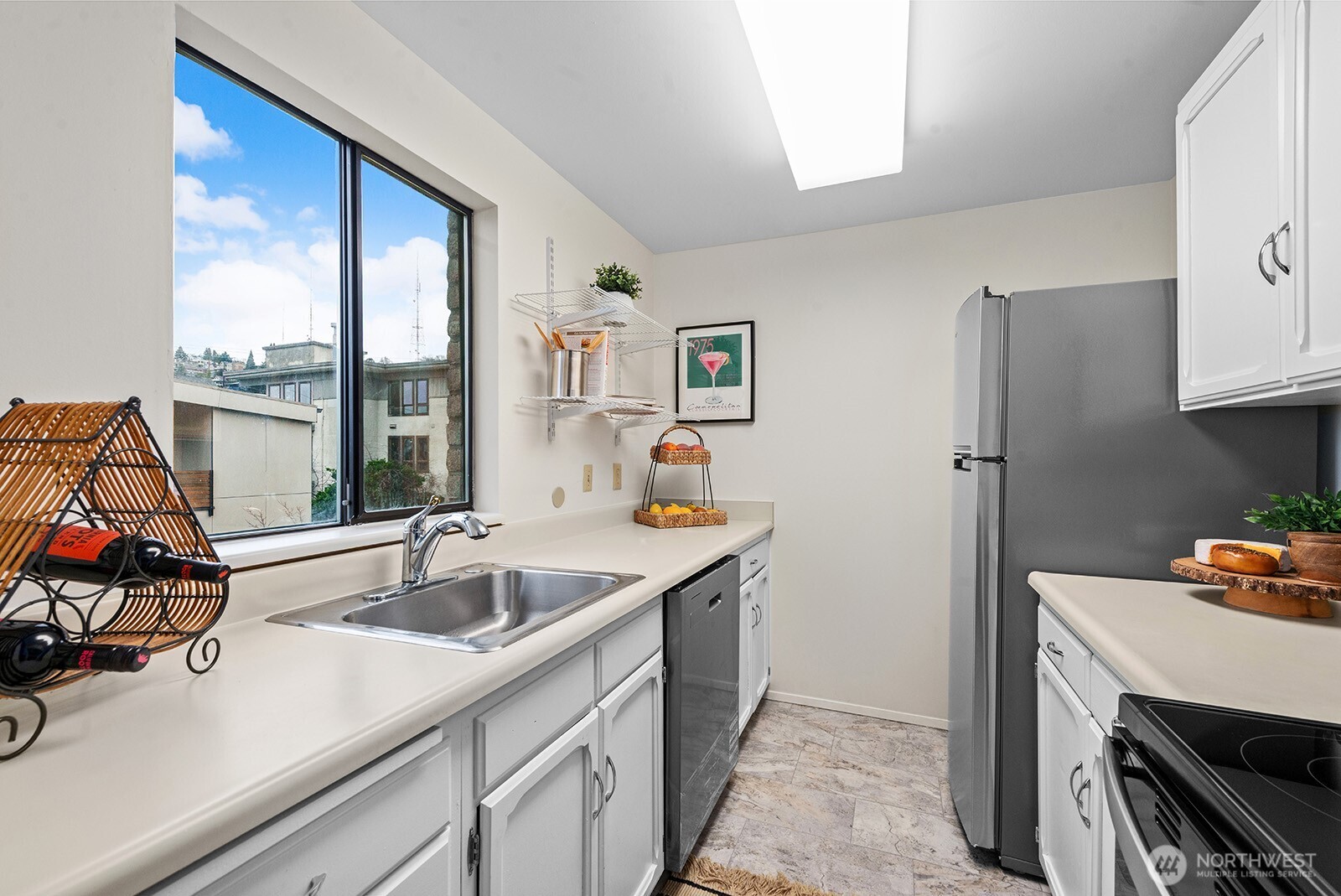 610 Aloha Street, Unit 404 Seattle, WA 98109 - Photo 13 of 23 a kitchen with a sink and a refrigerator