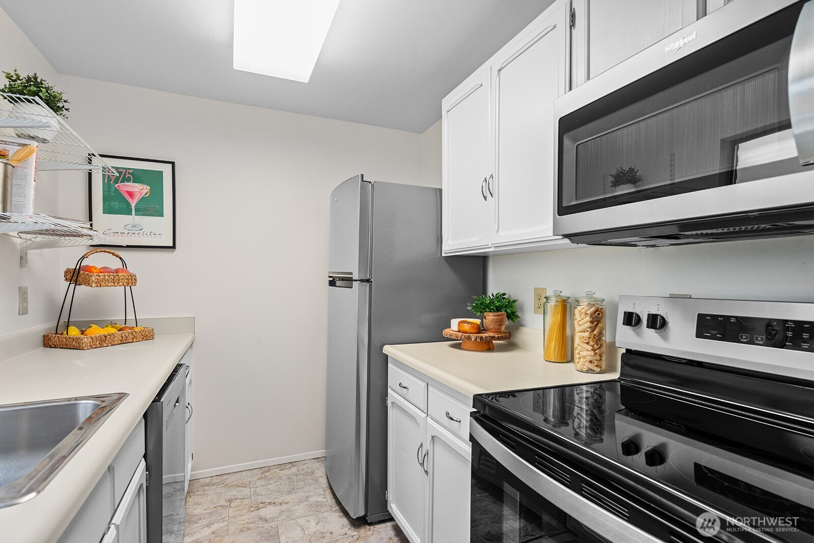610 Aloha Street, Unit 404 Seattle, WA 98109 - Photo 15 of 23 a kitchen with stainless steel appliances granite countertop a stove and a microwave