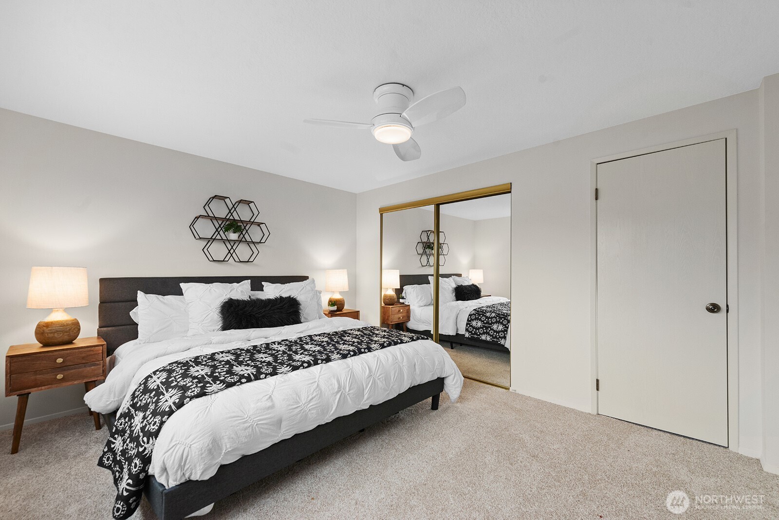 610 Aloha Street, Unit 404 Seattle, WA 98109 - Photo 17 of 23 a bedroom with a bed and a lamp