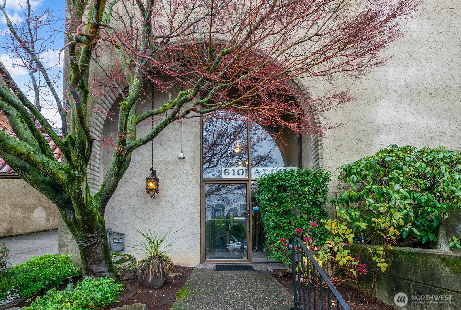 610 Aloha Street, Unit 404 Seattle, WA 98109 - Photo 2 of 23 a front view of a house with a tree