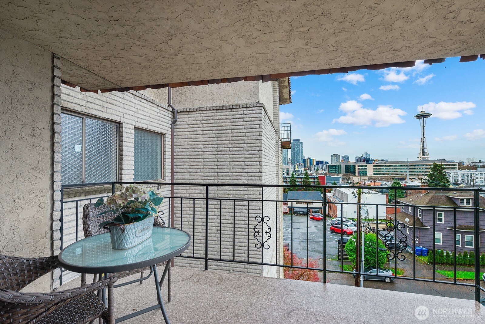 610 Aloha Street, Unit 404 Seattle, WA 98109 - Photo 21 of 23 a balcony with table and chairs