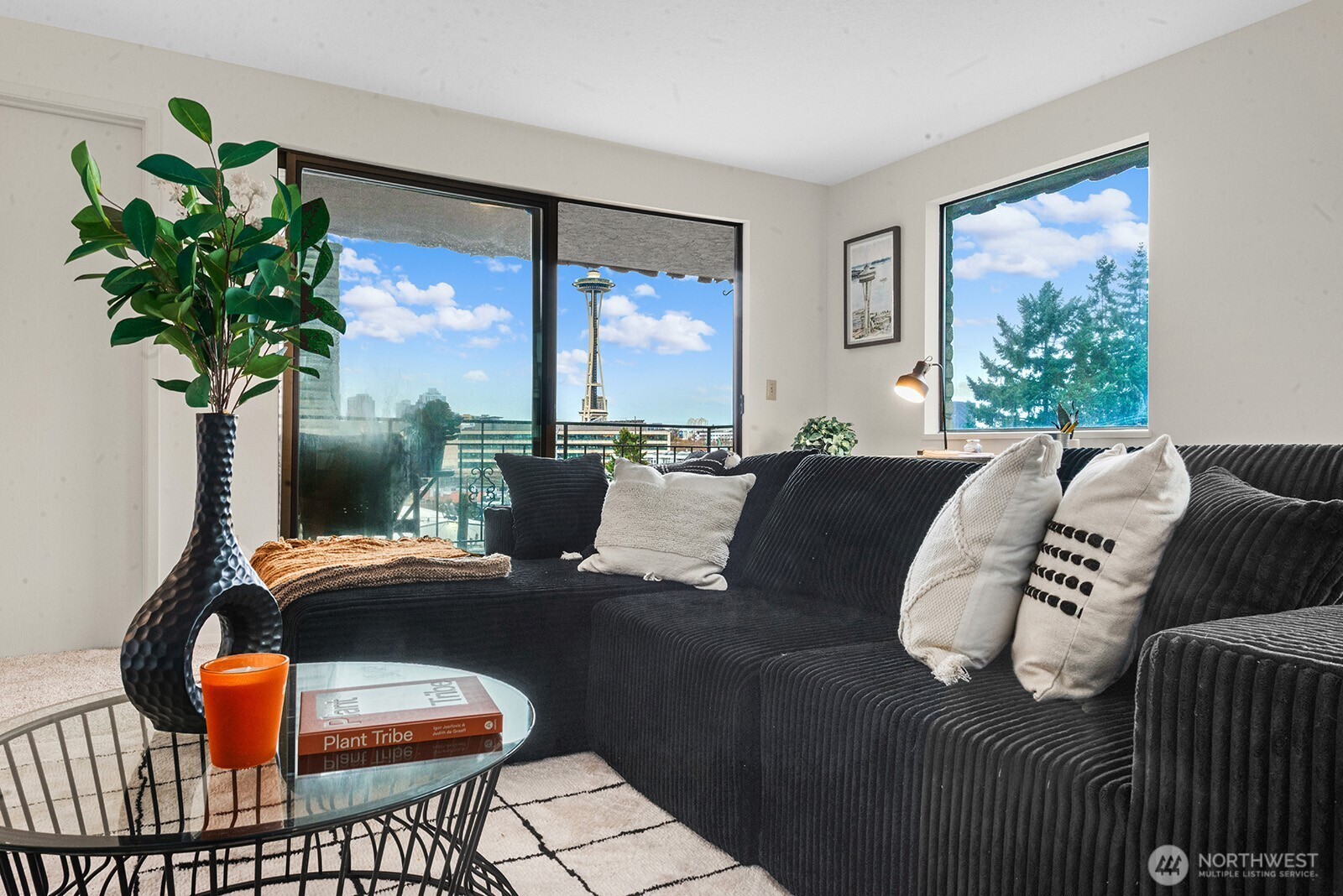 610 Aloha Street, Unit 404 Seattle, WA 98109 - Photo 6 of 23 a living room with furniture a chandelier and a large window