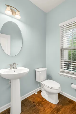 a bathroom with a toilet a sink and mirror