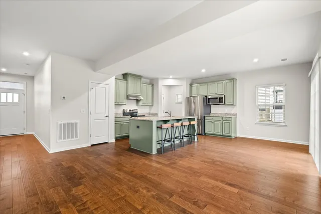 a view of kitchen with furniture and wooden floor