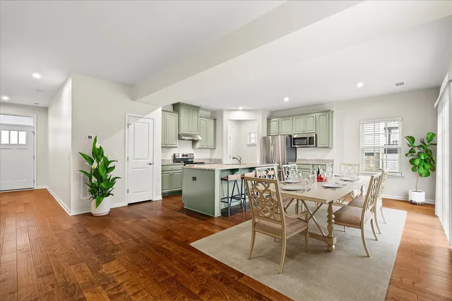 a view of a dining room with furniture and a kitchen