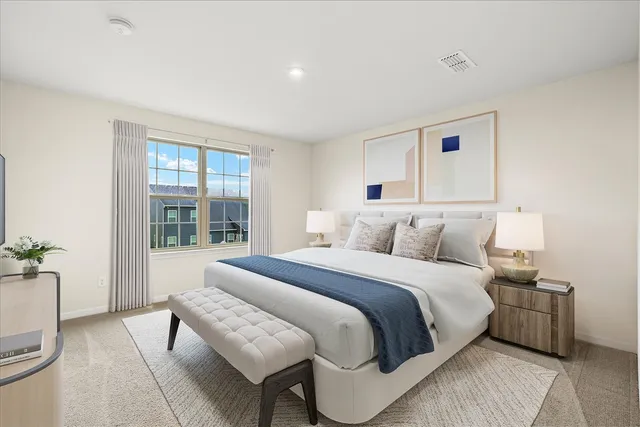 a spacious bedroom with a bed and a couch