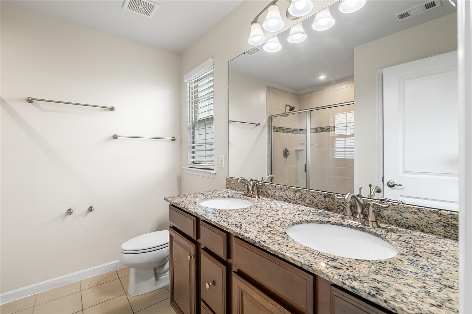 3204 Garrett Lane Columbia, TN 38401 - Photo 27 of 33 a bathroom with a granite countertop sink a mirror and a toilet