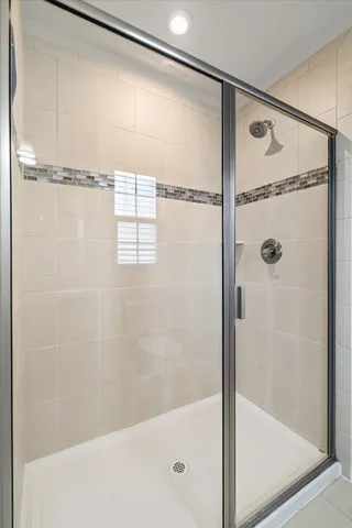 a bathroom with a glass shower door