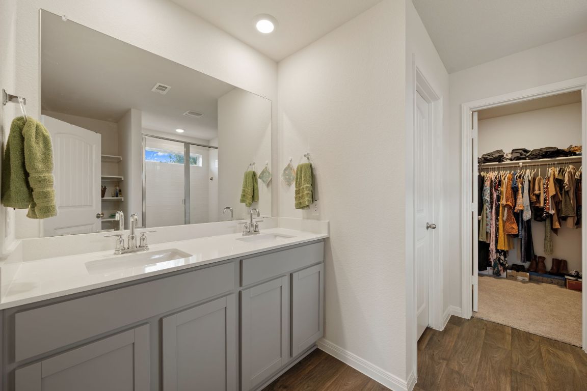 13908 Mamie Eisenhower Road Manor, TX 78653 - Photo 13 of 23 a en suite bathroom with a sink and a mirror