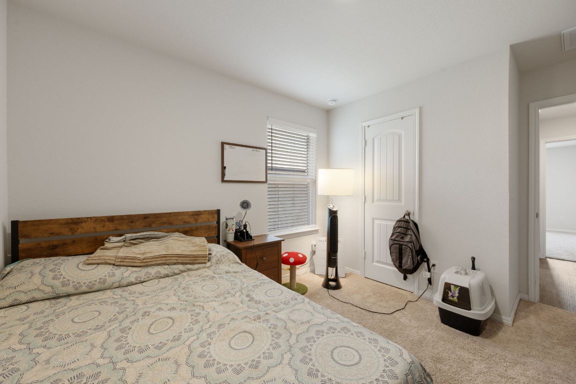 13908 Mamie Eisenhower Road Manor, TX 78653 - Photo 18 of 23 a bedroom with a bed and a dresser
