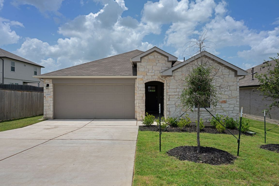 13908 Mamie Eisenhower Road Manor, TX 78653 - Photo 2 of 23 a front view of a house with garden